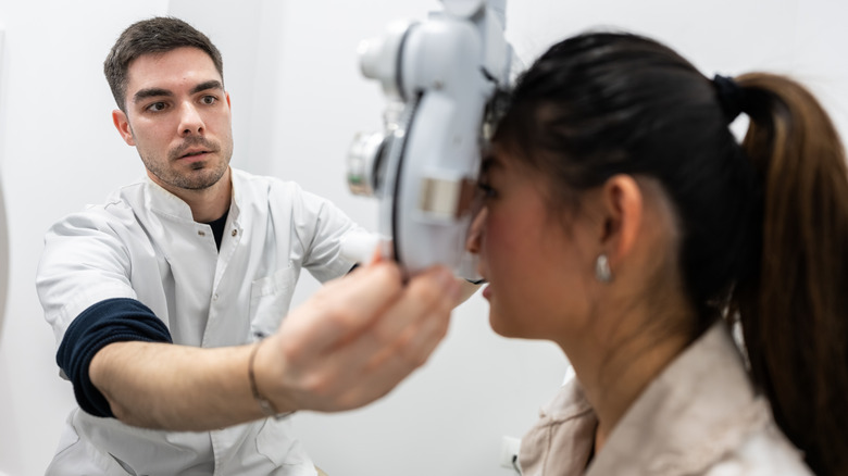 A woman at the optometrist having her eyes examined