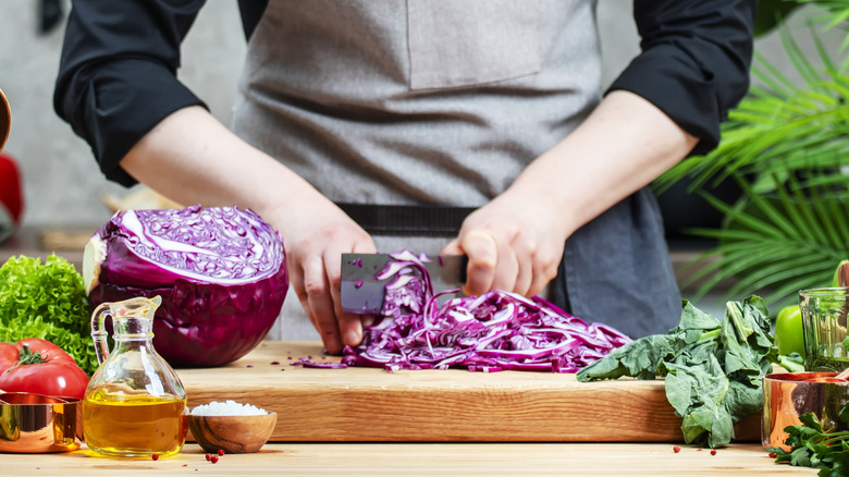 chef chopping purple cabbage