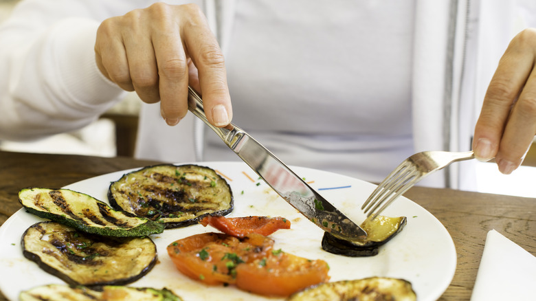 Woman eating eggplant