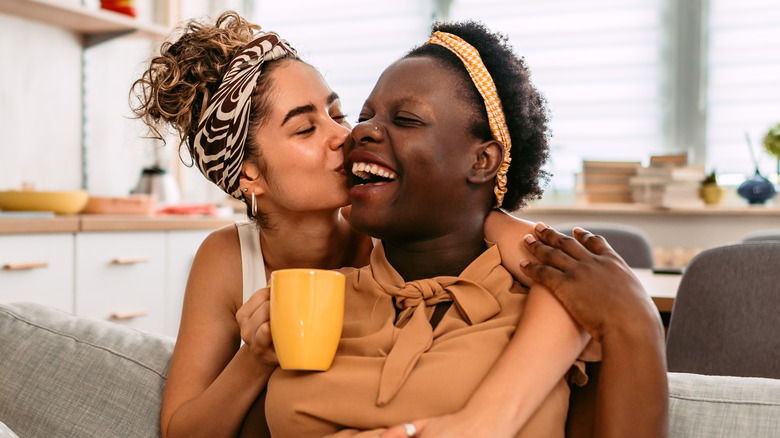 Smiling couple kissing on cheek