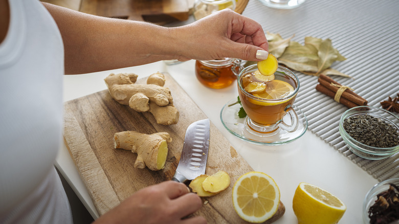 Hands preparing ginger tea
