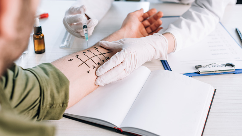 man being tested for allergies by medical staff