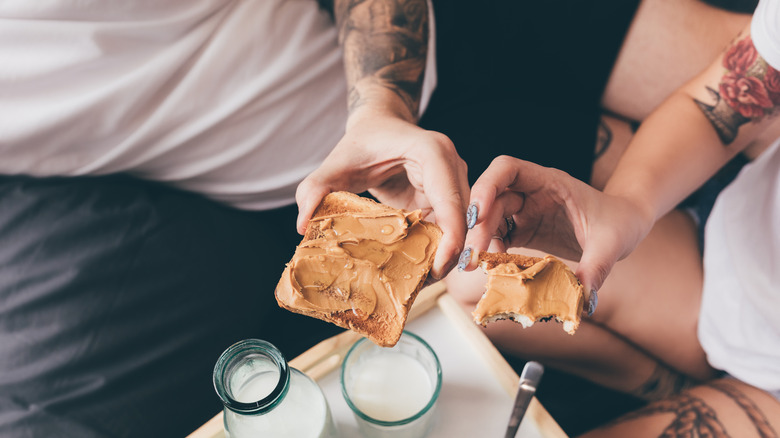 Couple eating peanut butter on toast