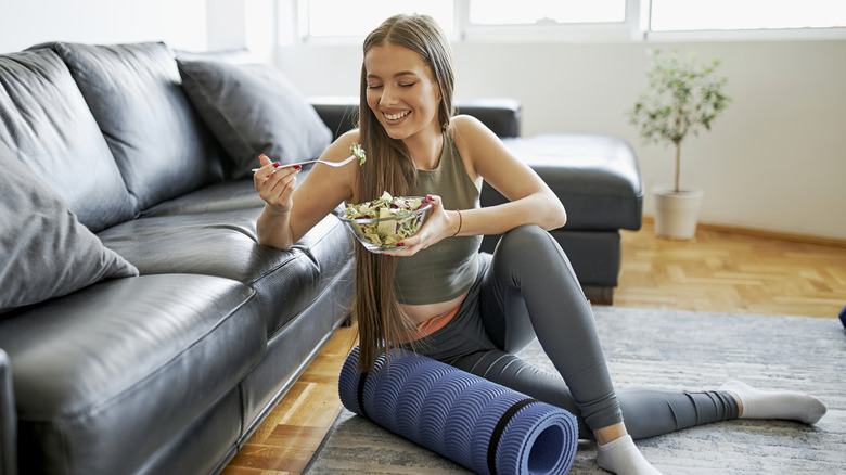 Woman eating salad after workout