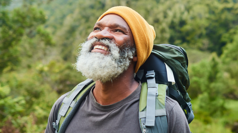 man smiling while hiking