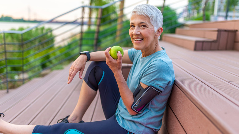 A woman eats an apple