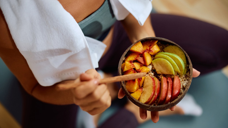 woman holding a bowl of fruit