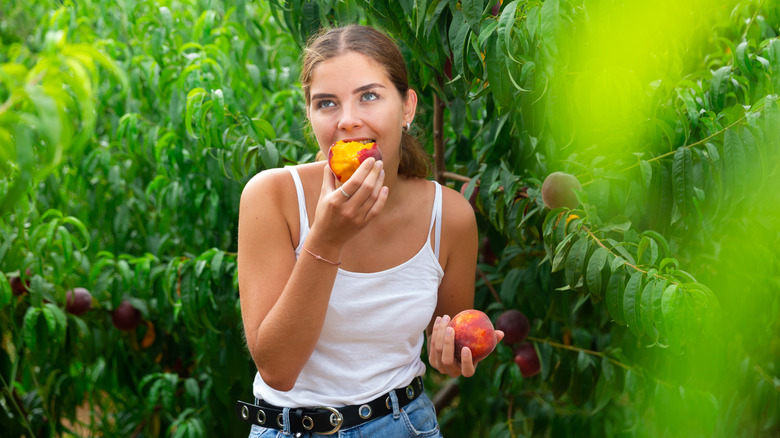 girl eating a peach