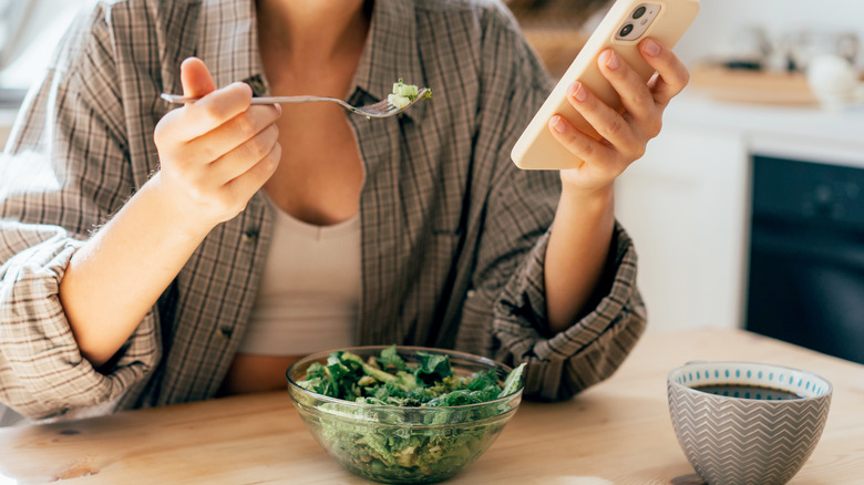 Individual eating spinach salad