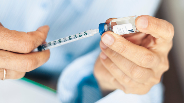 Hand preparing insulin injection