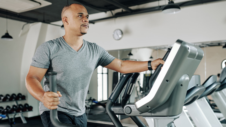 A man uses an elliptical machine