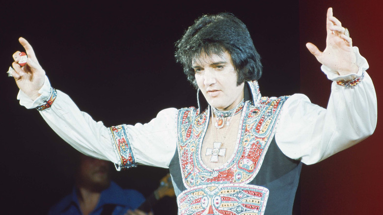 Elvis Presley on stage in elaborate costume