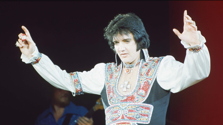 Elvis Presley on stage in elaborate costume