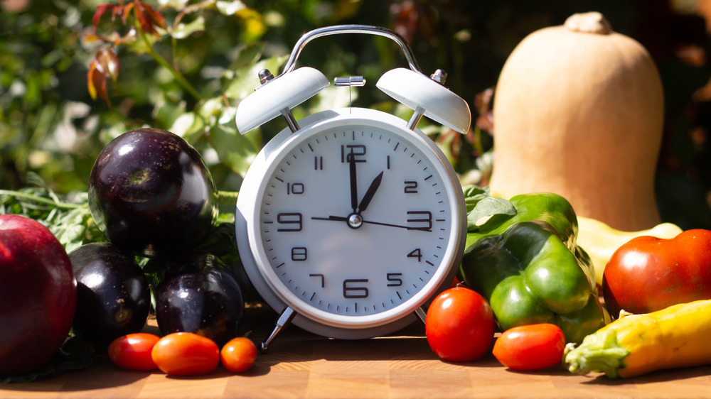 clock surrounded by vegetables
