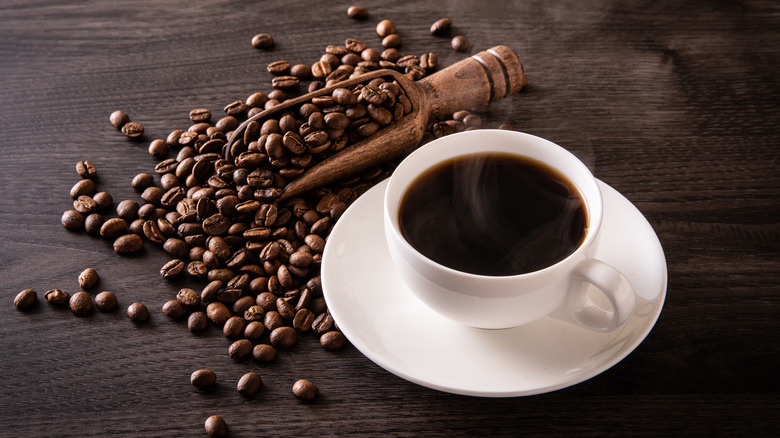 coffee beans and mug on table