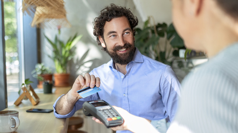 man making purchase with credit card