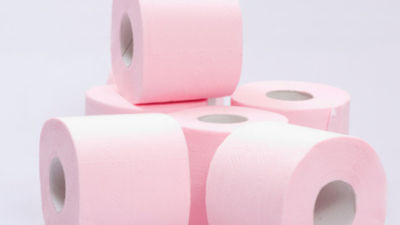 rolls of pink toilet paper stacked