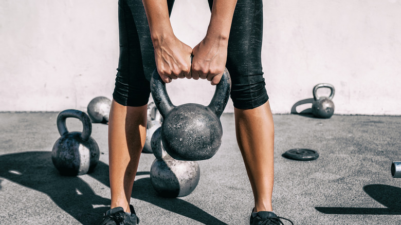 person holding kettlebell while working out