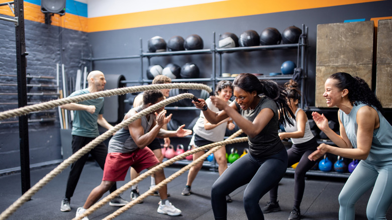 people doing battle rope workout at CrossFit gym