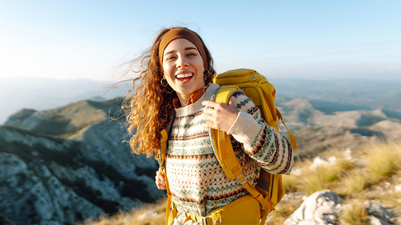 A smiling woman hiking