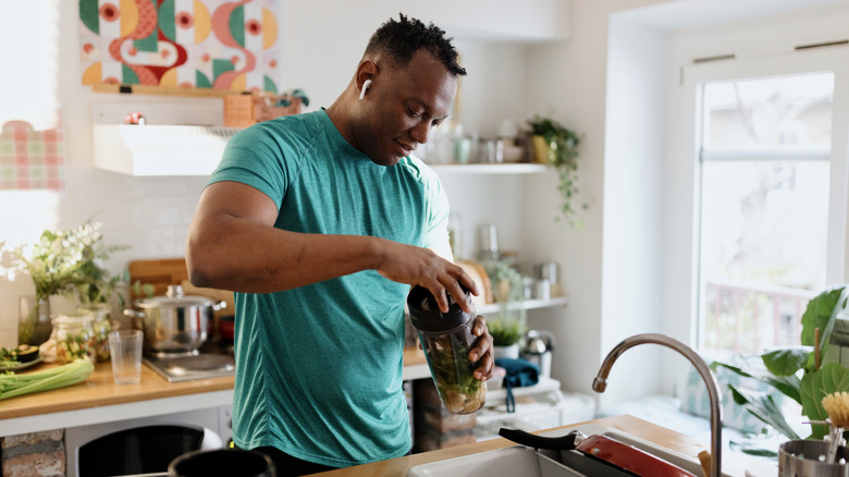 man making a healthy smoothie