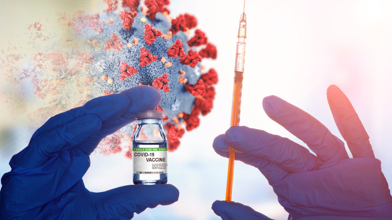 COVID-19 vaccine with syringe and covid virus in background 