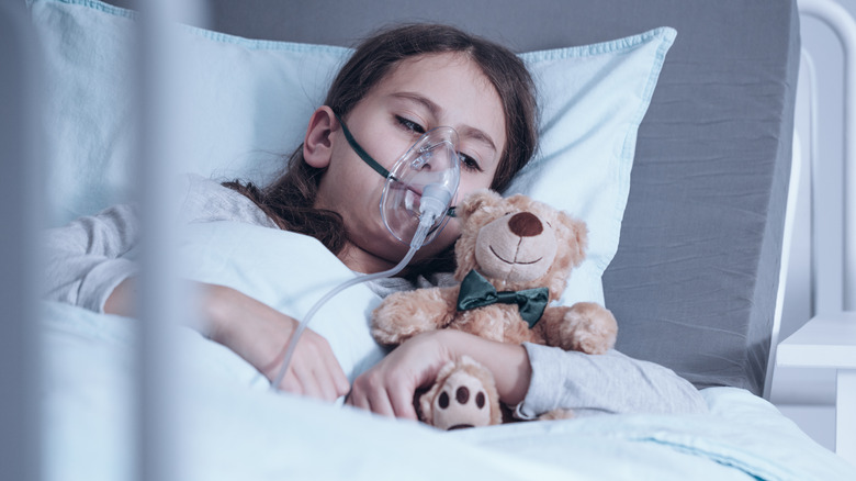 kid with cystic fibrosis lying in hospital