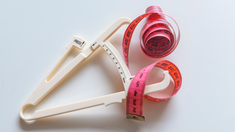 body fat calipers and measuring tape