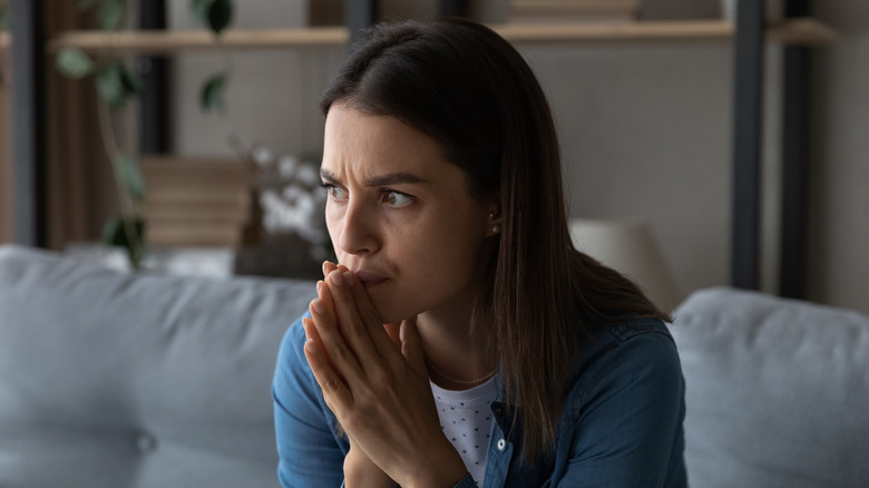 Woman with anxiety sitting on couch