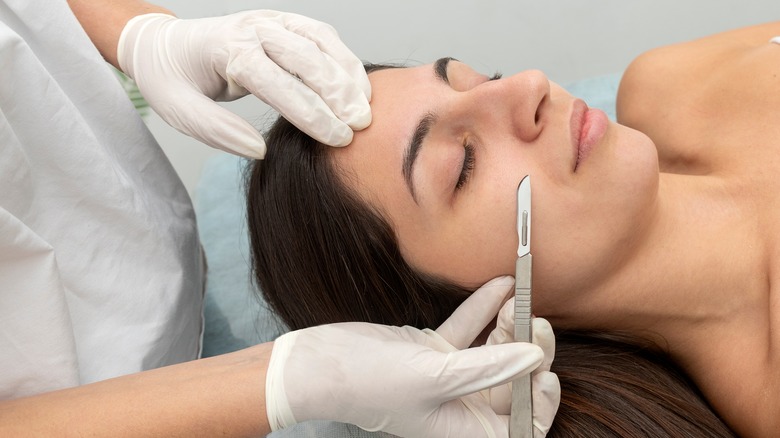 A woman receives a dermaplaning treatment