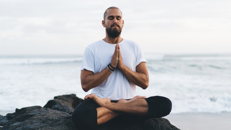 man sitting in lotus pose