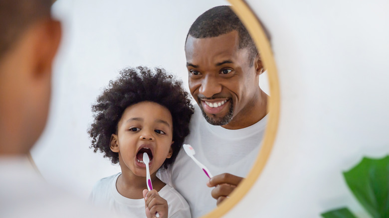 Man and child looking in mirror