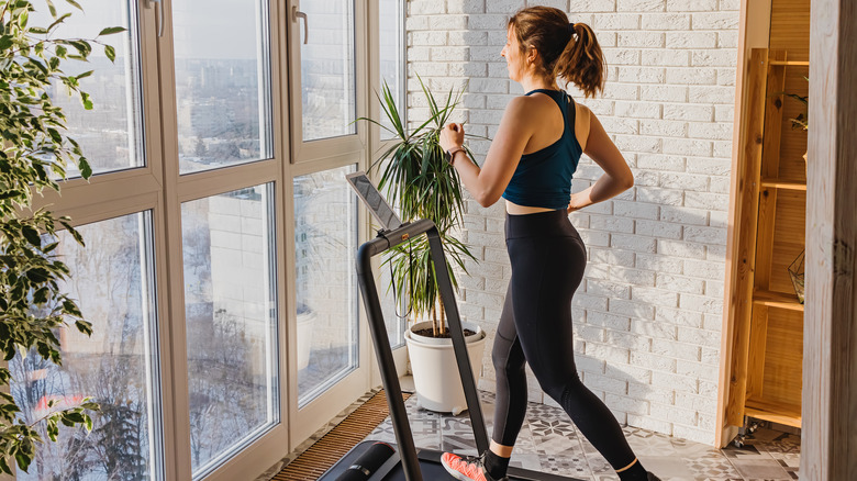 A woman walks on a treadmill