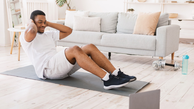 A man exercises at home