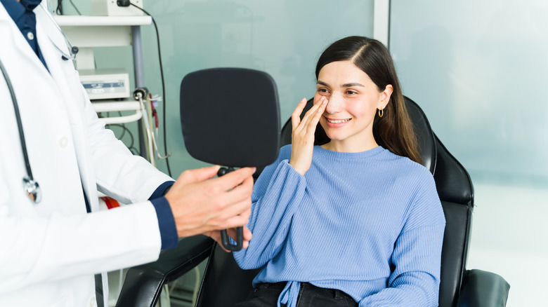 A woman is happy after a nose job