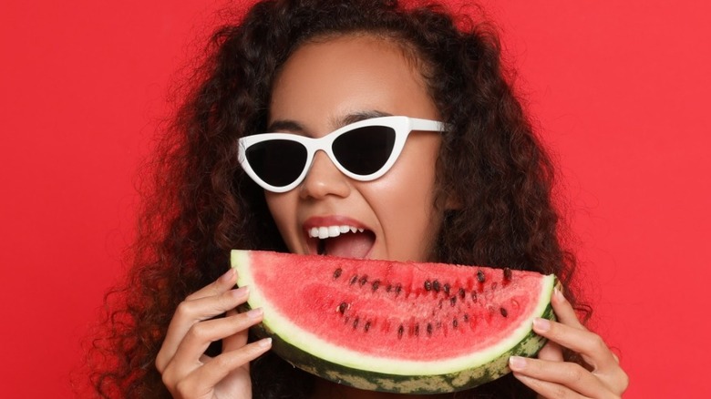 African American woman eating watermelon