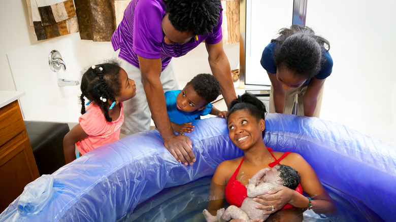Family greeting new baby
