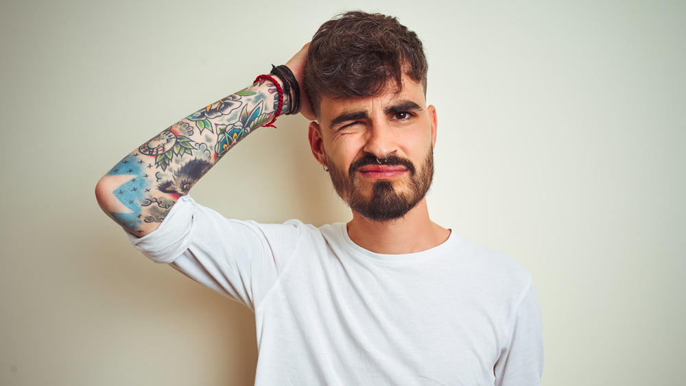 confused tattooed man