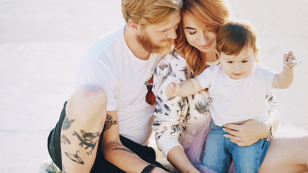 tattooed man outside with family