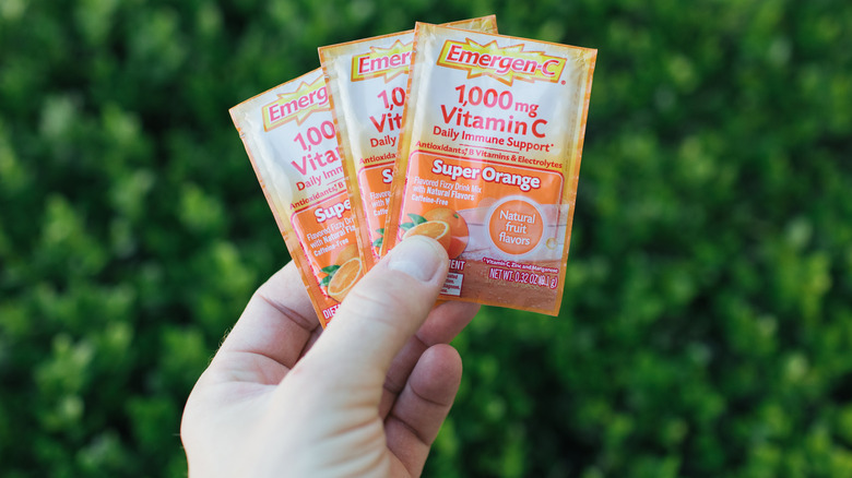 Man holding three packets of Emergen-C