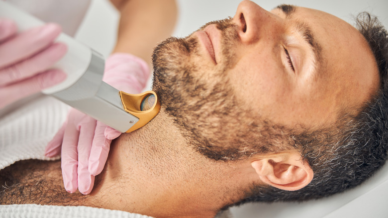 man getting laser hair removal on neck