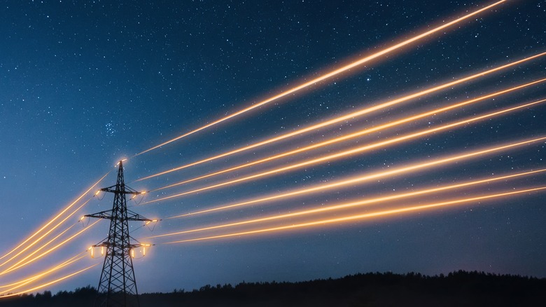 Electric wires against night sky