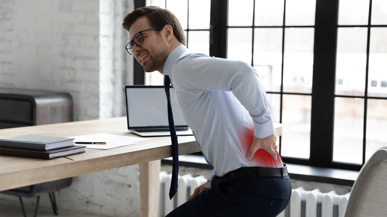 man feeling lower back pain