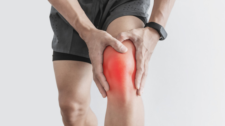 man holding sore knee