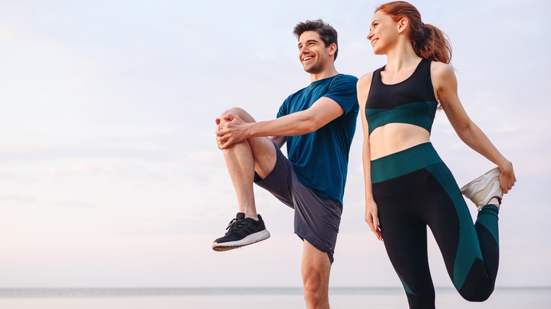 Man and woman stretching