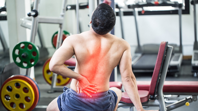 man exercising at gym back pain