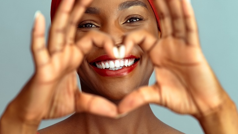 Woman making heart shape with hands