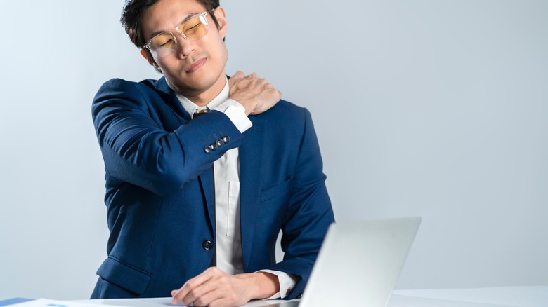 man holding neck in pain