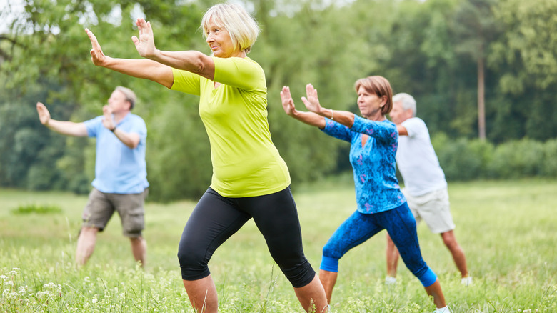 People practicing tai chi outside