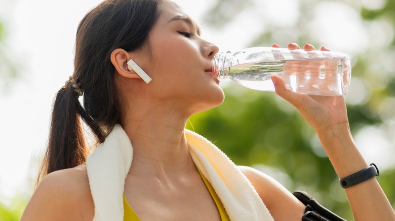 Woman drinking from water bottle